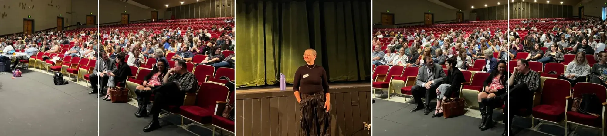 A large auditorium full of people attending a presentation