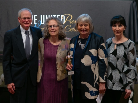 four people accepting an award