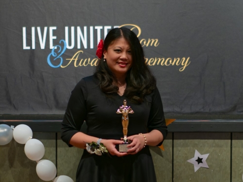 smiling woman holding award