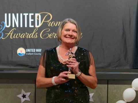 smiling woman holding award