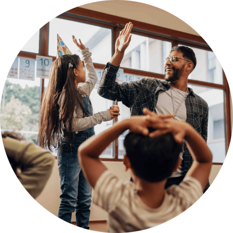 student and teacher giving high five