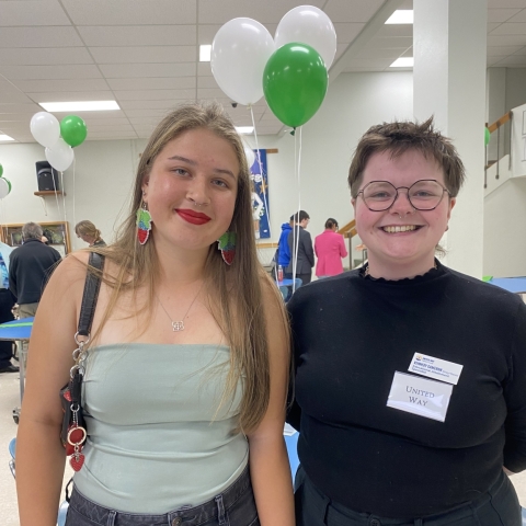 two smiling young people facing the camera