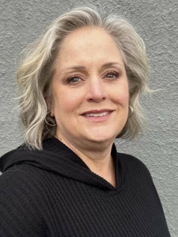 headshot of woman with light blonde short wavy hair