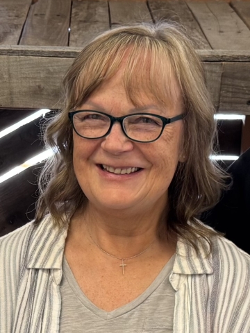 headshot of older woman with blonde wavy hair