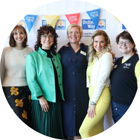 five smiling people in front of a United Way banner