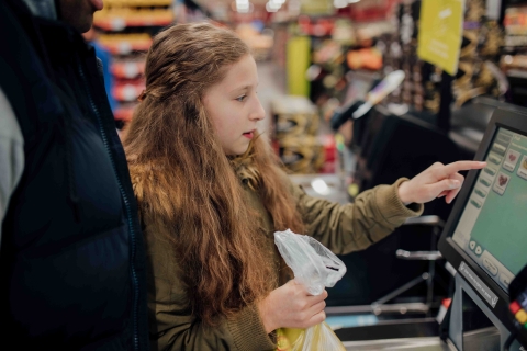 girl paying for groceries