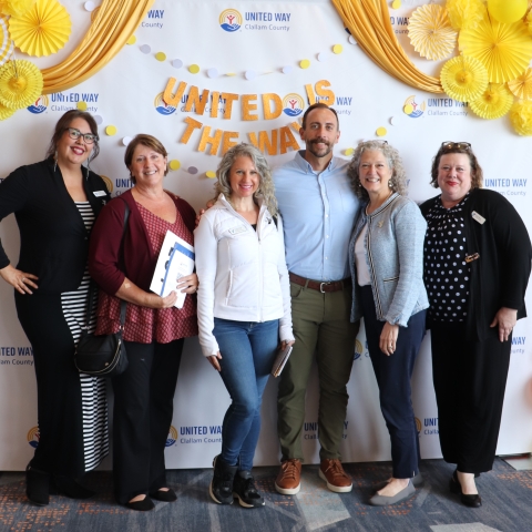 Smiling group of people in front of bright background