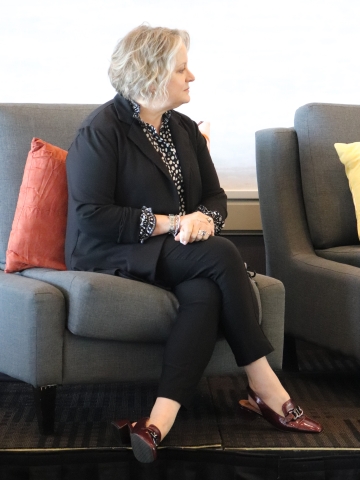 woman with short hair sitting on a comfy chair