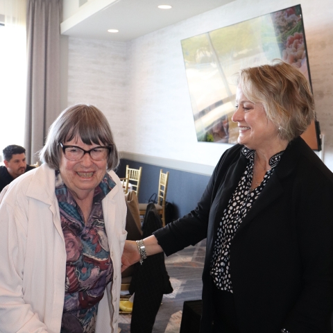 two women smiling together