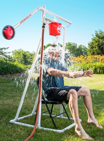 a man having a bucket of water dumped on his head