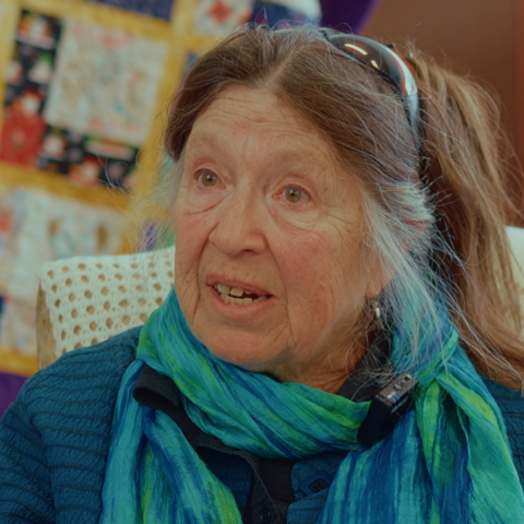 elderly woman in a silk scarf