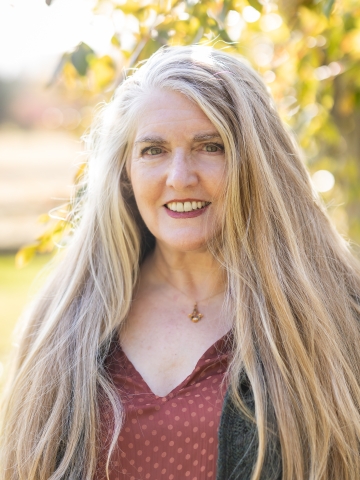 Smiling woman outside with long light blonde hair