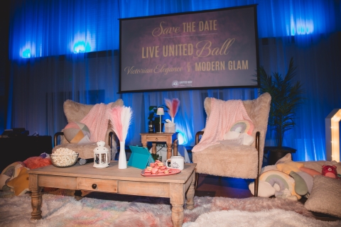 cozy chairs and coffee table set up on a stage