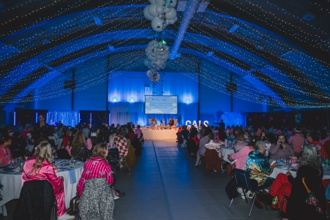 Large event hall filled with blue light