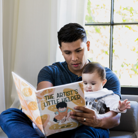 Dad reading book with baby