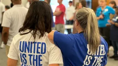 two people with shirts reading "United is the Way"