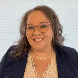 Smiling woman with dark blonde hair and glasses