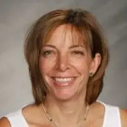 Smiling woman with shoulder length dark blonde hair