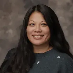 Headshot of smiling woman with long dark hair